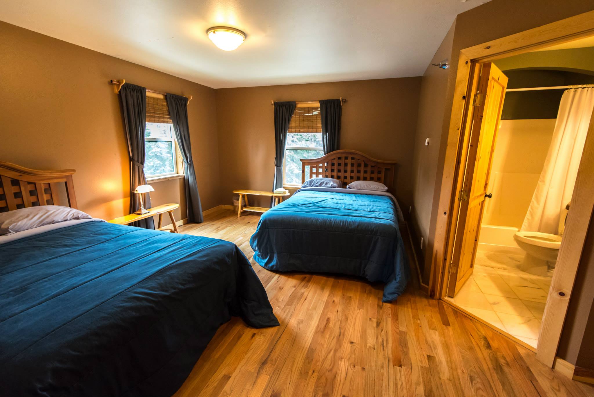 Wooden floor bedroom with blue bedding