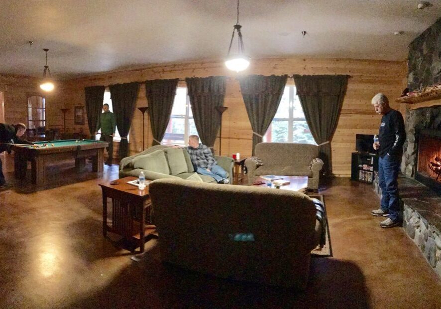 Cabin interior with pool table and sofas