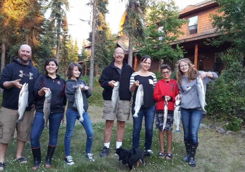 Family displaying caught fish